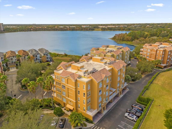 Panoramic view showing multiple multi-story residential buildings near a large body of water.