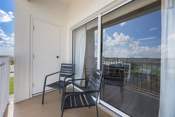 Balcony with two chairs, offering a view of the surroundings.