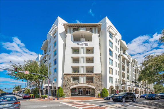 Front view of a multi-story building with balconies and modern architectural design.
