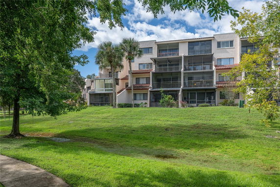 Front view of a multi-story residential building with balconies.