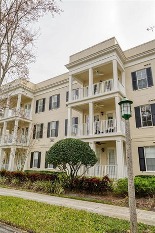 Front view of a three-story apartment building with balconies.