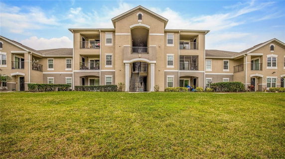 Front view of a three-story apartment building with balconies.