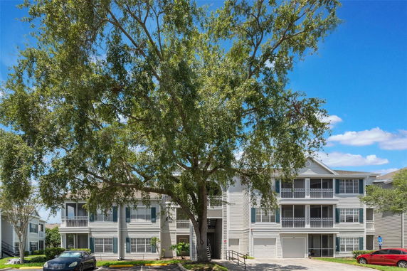 Front view of a multi-story residential building with balconies.
