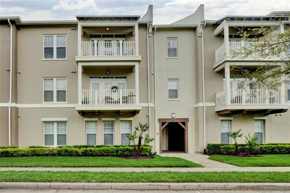 Front view of a multi-story residential building with multiple balconies.