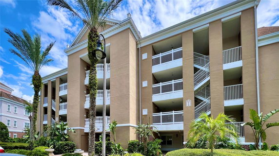 Front view of a multi-story apartment building with balconies and exterior staircases.