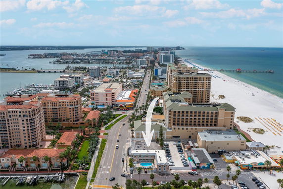 Aerial view of a coastal cityscape with buildings and a beach along the shoreline.