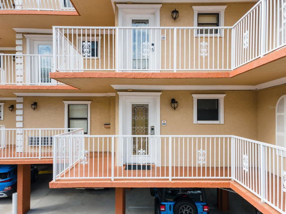 Front view of a multi-story building with balconies.