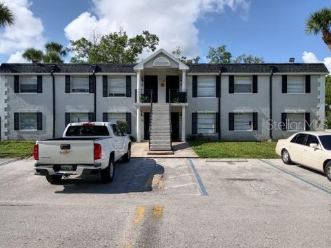 Front view of a two-story apartment building with a central staircase.