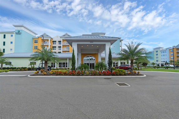 Front view of a multi-story building with colorful exterior and main entrance.