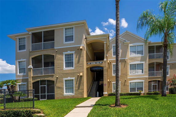 Front view of a multi-story apartment building with balconies.