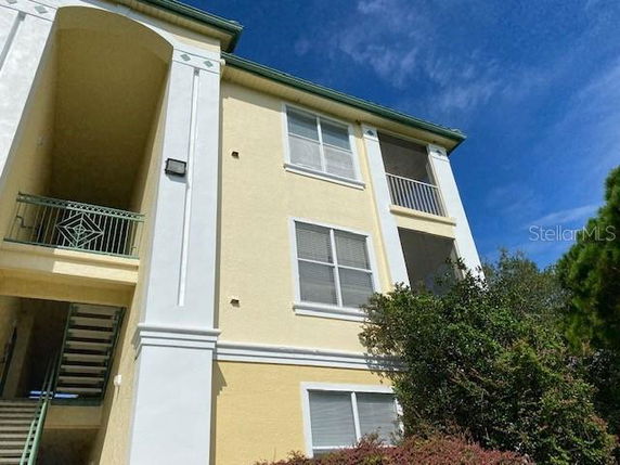 Front view of a multi-story building with balconies.