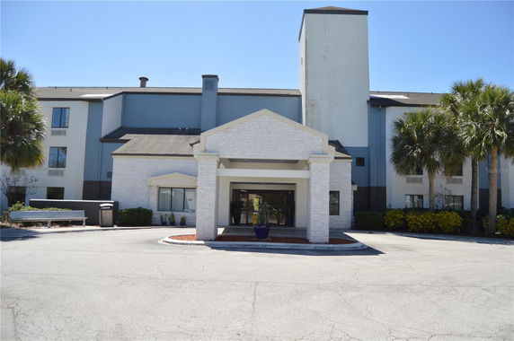 Front view of a multi-story building with an entrance canopy.