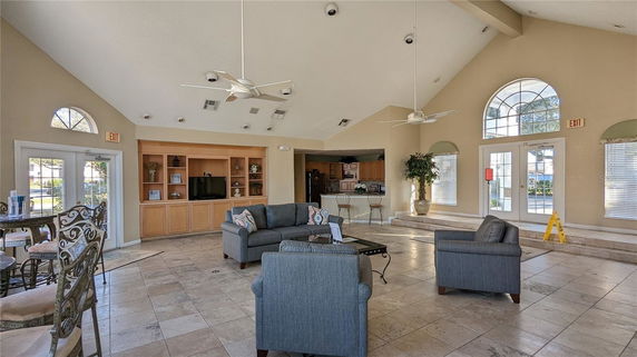 Spacious clubhouse interior with sofas and television.