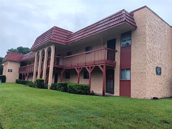 Front view of a two-story building with arched entrances and balconies.
