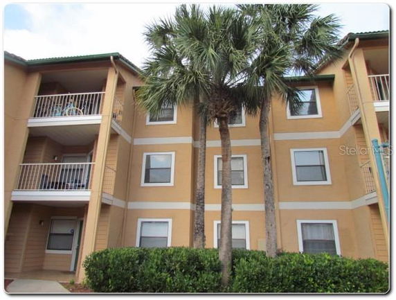 Front view of a multi-story apartment building with balconies.
