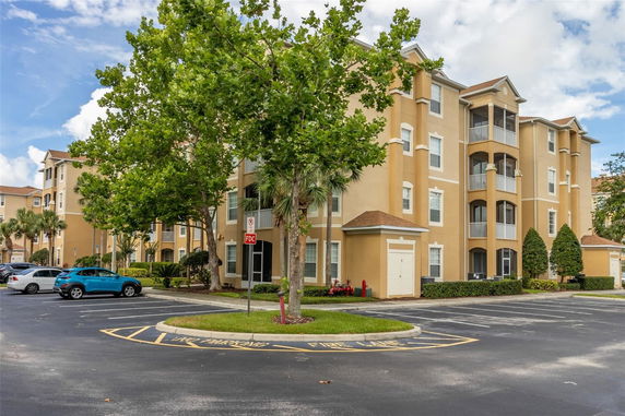 Front view of a multi-story apartment building with balconies.
