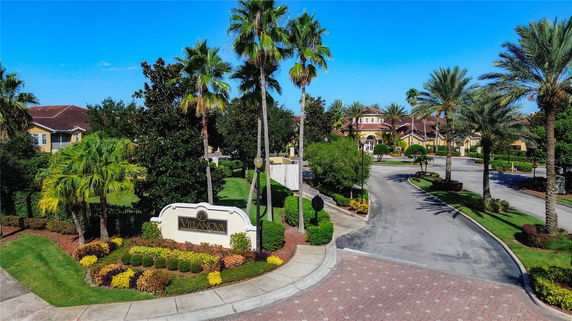 Front view of a residential community entrance with a sign reading 'Villanova'.