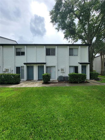Front view of a two-story residential building with multiple entrances.