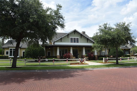Front view of a single-story house with a gabled roof and a porch.