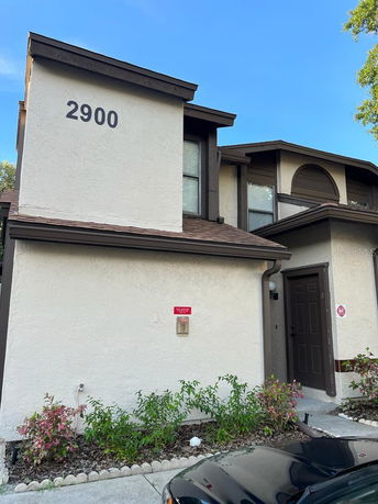 Front view of a two-story house with a visible door and windows, numbered 2900.