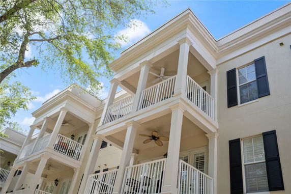 Front view of a multi-story building with balconies and columns.