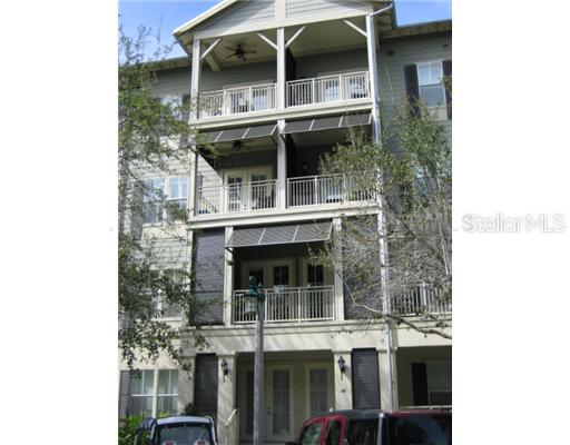 Front view of a multi-story building with multiple balconies.