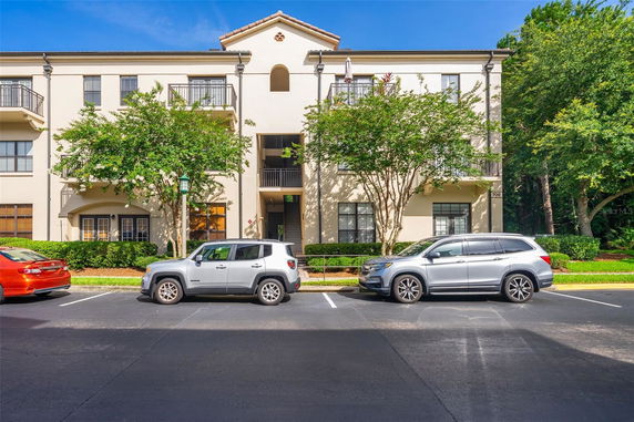 Front view of a three-story residential building with balconies.