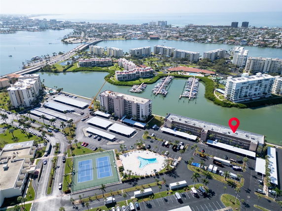 Panoramic view of buildings, parking areas, and waterways in a coastal area.