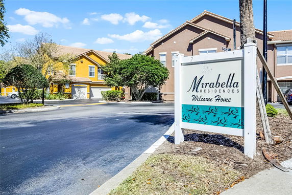 Front view of a residential building with a sign for Mirabella Residences.