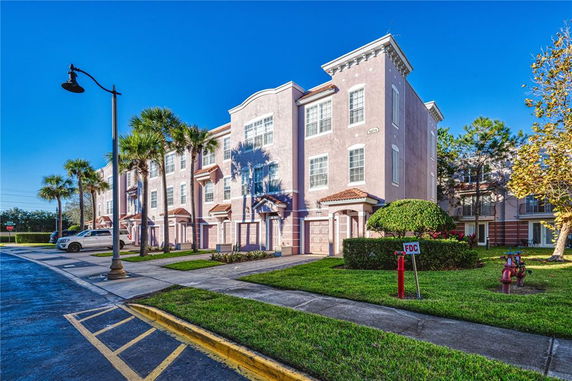 Front view of a multi-story residential building with multiple units.