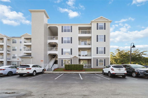 Front view of a multi-story residential building with balconies.