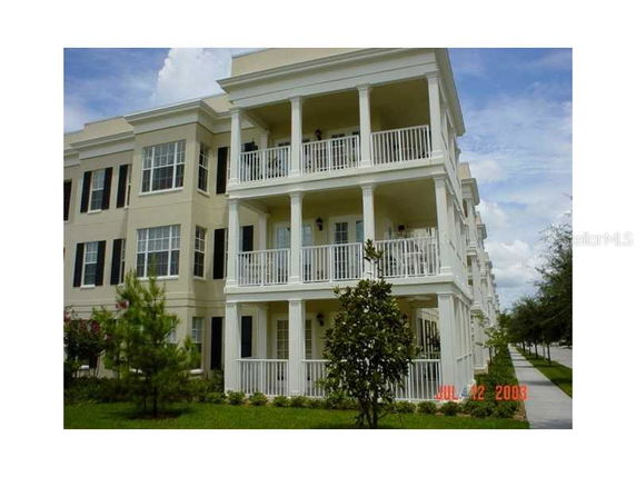 Front view of a multi-story residential building with balconies.
