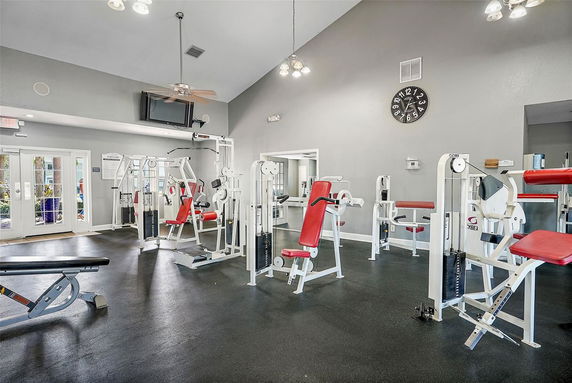 Indoor gym area with exercise machines and equipment.