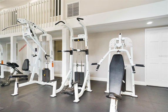 Indoor gym area with various exercise machines.