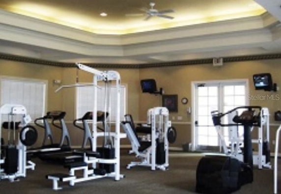 Indoor gym area with exercise machines and equipment.
