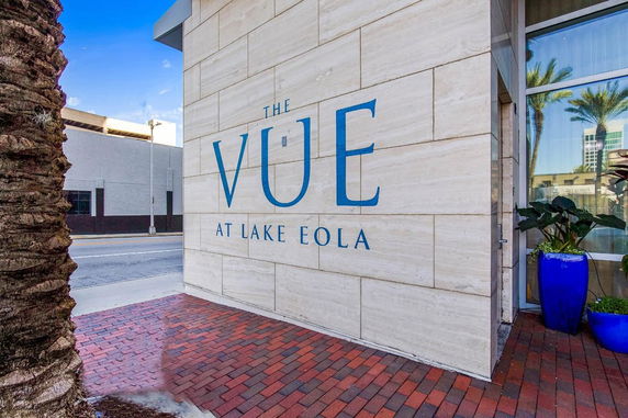Front view of a modern building with signage for 'The Vue at Lake Eola'.