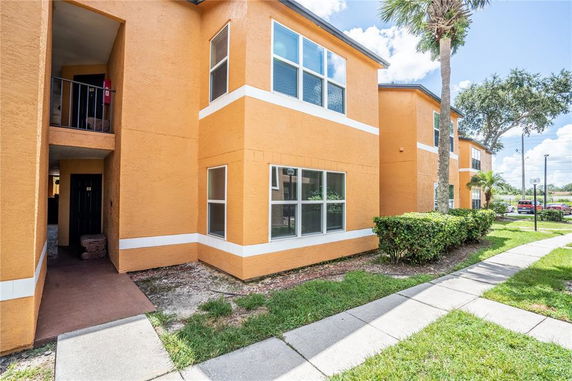 Front view of a multi-level orange apartment building.