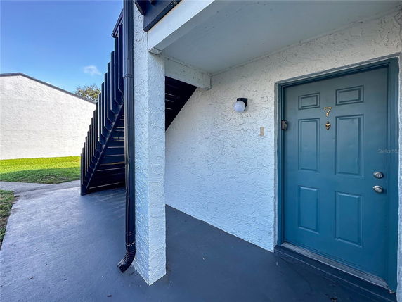 Front view of a building entrance with a staircase and door number 7.