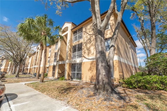 Front view of a multi-story apartment building with balconies.