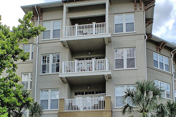 Front view of a multi-story residential building with balconies.
