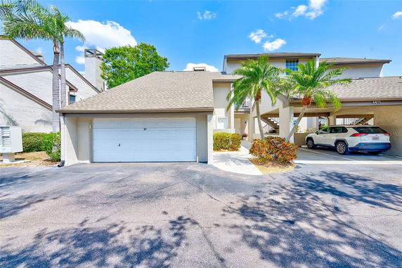 Front view of a house with a double garage and covered parking area.