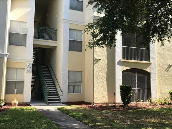 Front view of a multi-story building with exterior staircases.