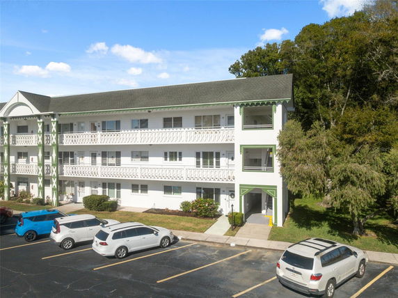 Front view of a three-story apartment building with balconies.