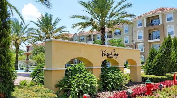 Front view of a multi-story resort building with balconies and a prominent sign reading 'Vista Cay Resort'.