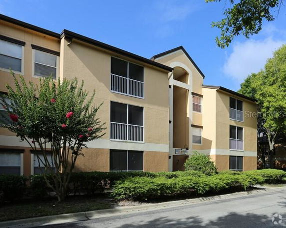 Front view of a three-story apartment building with balconies.