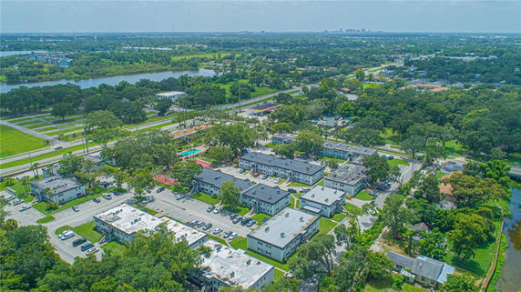 Aerial view of a residential area with multiple buildings, roads, and surrounding greenery.