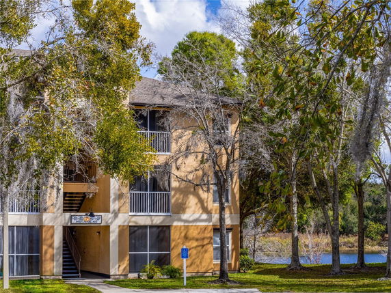 Front view of a multi-story apartment building with balconies.