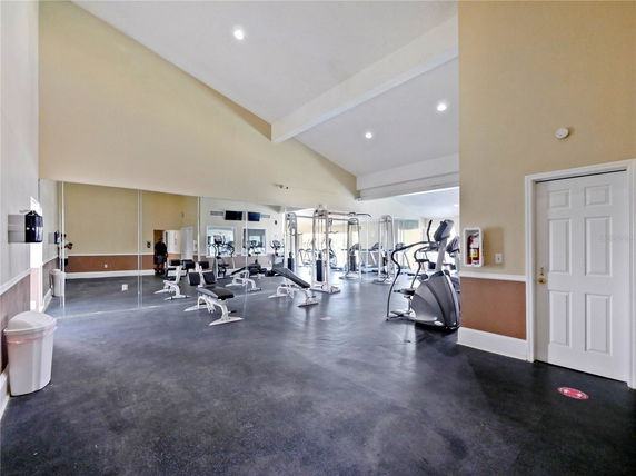 Indoor gym area with exercise machines and equipment.
