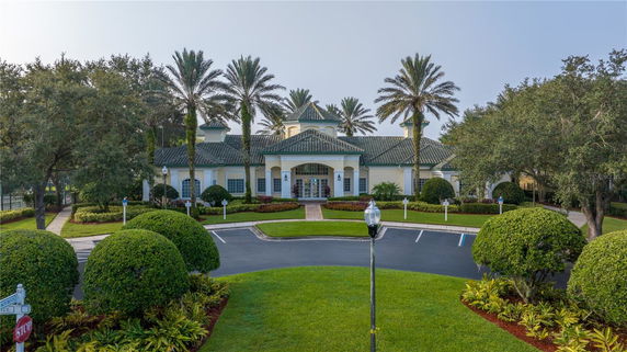 Front view of a large building with multiple entrances and a green tiled roof.