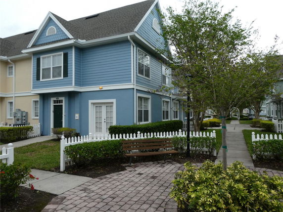 Front view of a two-story house with blue siding and white trim.